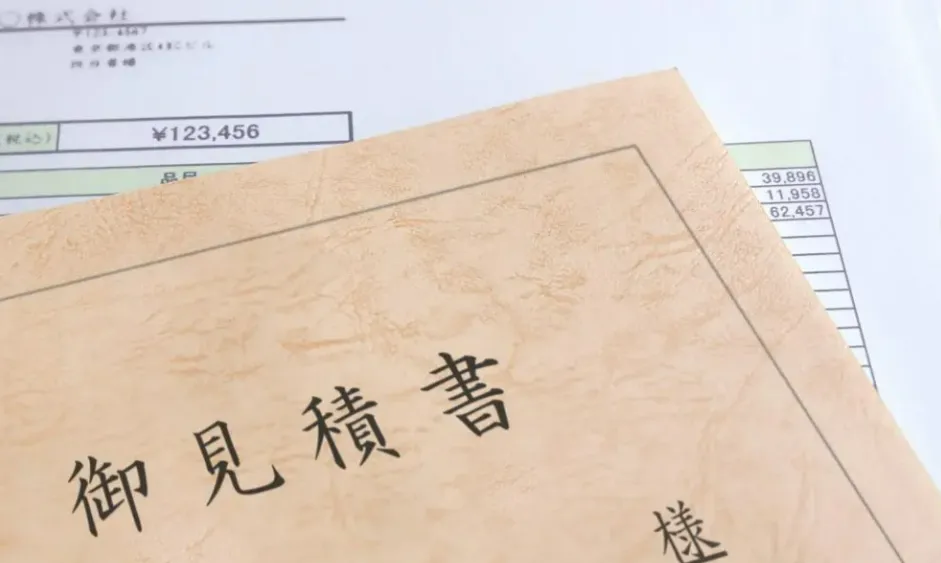 見積書と電卓・住宅模型のイメージ写真